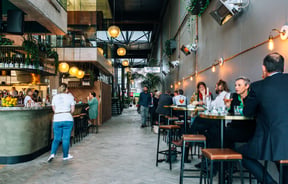 Customers dining inside Mr Pickles a restaurant within Riverbank Lane.