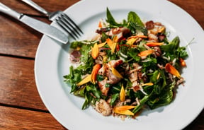 Close up of vibrant green thai squid salad