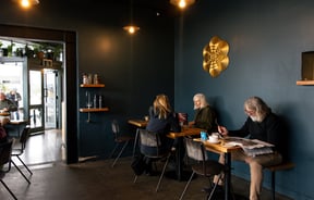 Customers dining inside a cafe painted blue.