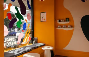 The yellow and white painted interior of Small Mercies Auckland.