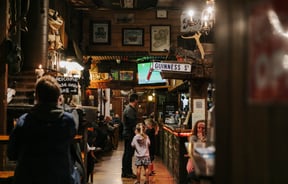 Man standing at the bar with his children at Strawberry Tree.
