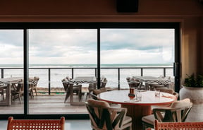 A view of the beach from inside Tahu restaurant Gisborne.