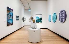 White walls with exhibits on display on the wall at Waikato Museum.