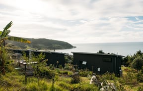 The Huts accommodation and view to the ocean.