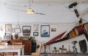 Old artifacts on a dresser and land yacht at The Terraces with table in foreground in Ōamaru.