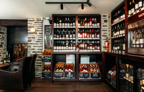 Bottles of wine on display on shelves.