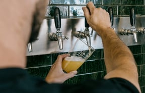 Worker pulling a pint using large wooden handles.