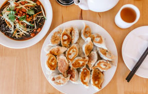 A birdseye view of a large plate of dumplings.