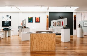 A large gallery full of colourful works of art.