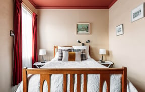 A bed in a hotel room.