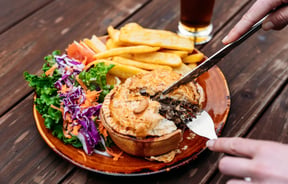 A close up of a pie being cut into.