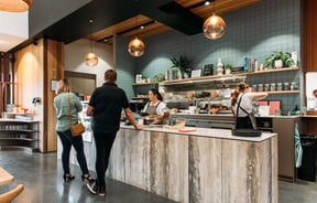 Customers ordering at the counter inside Weave Eatery.