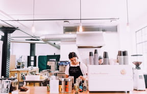 A barista making coffee.