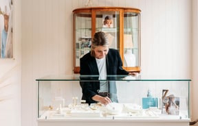 Woman reaching into jewellery cabinet at Whistle & Pop