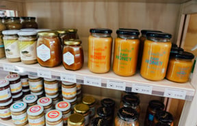 Jars of honey on the shelves.
