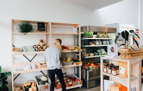 Worker tends to the products on shelves.