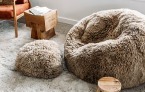 Close up of sheepskin cushions of different shades of brown at Wilson & Dorset, Wānaka.