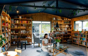 Two people sitting and reading at Hub Matakana.