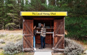 Two customers inside the roadside stall of Forage and Gold.