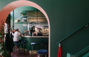 Interior view of gin gin feature green and pink contrast archway.