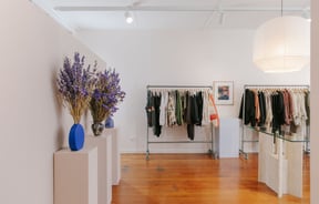 Clothing on display on racks inside Company Store Dunedin.