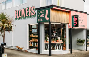 The green, pink and grey exterior of The Wilderness florist store in Paraparaumu.