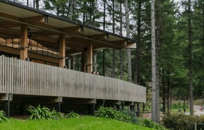 A big wooden building in the forest at Christchurch adventure park.