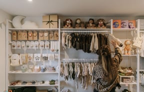 Customer browsing a selection of kidswear at Lily & Langford in Christchurch