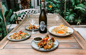 Plates of food on an outdoor table at Bandung Cafe.
