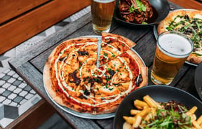 Pizza and other food on the table.