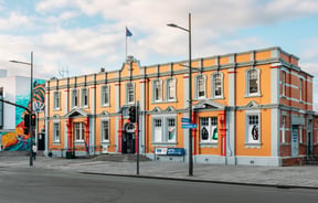 Exterior of Arts Post Building in Hamilton with street in front of it.