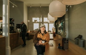 Christchurch cafe owner Sung Park drinking a coffee in the sun-drenched space of Akin