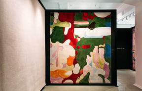 A colourful rug on a wall at Hanrad Bespoke Rugs Hamilton.