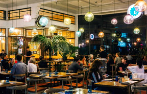 Customers dining under colourful bulbs at Gemmayze Street in Auckland.
