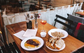 Pasta and bread on a table at Pick in Auckland.