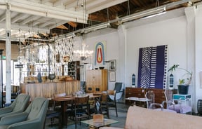 Chairs, lamps and artwork on display in a vintage store.