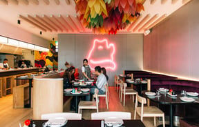 A group of customers sitting at a table inside Hello Beasty in Auckland.