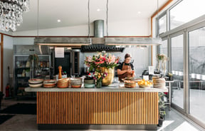 A woman working behind the cafe counter at Packing Shed.