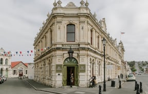 An old Oamaru stone building on a cloudy day.