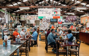 People dining at tables inside an Italian restaurant.