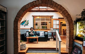 A woman sitting on a couch in a cafe.
