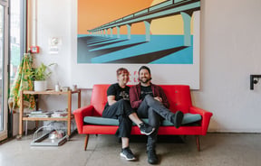 Sam and Caroline sitting on the couch at The Burger Joint, New Brighton.