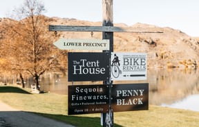 A lake view in Cromwell with signs in the forefront.