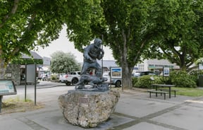 A sculpture of a man and his dog.