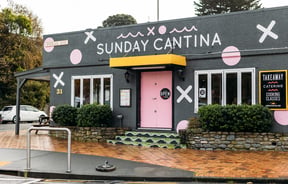 A colourfully decorated building that houses 'Sunday Cantina' cafe.
