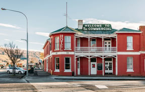 A red Roxburgh building on a sunny day.
