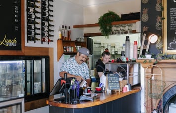 Two people behind the counter at Beach House Cafe.