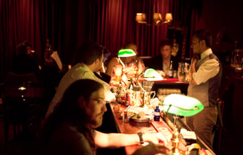 Green lamps on bar counter.