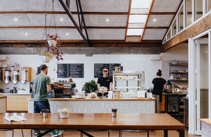 Two employees working behind the cafe counter at Allpress Espresso in Christchurch.