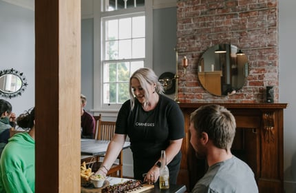 Waitress serving a table at Carnegie's Restaurant and Bar, Fairlie.